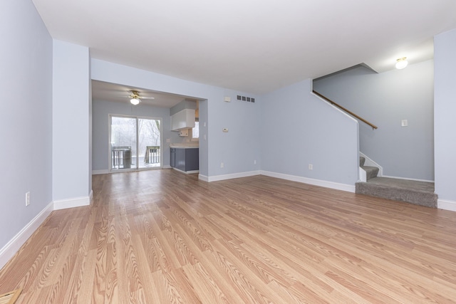 unfurnished living room with ceiling fan and light hardwood / wood-style floors