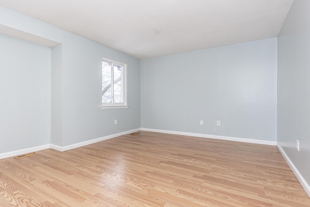 empty room with light hardwood / wood-style flooring