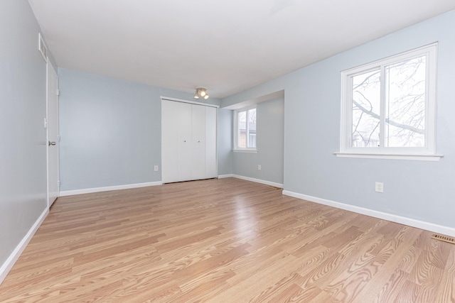 empty room with light hardwood / wood-style floors