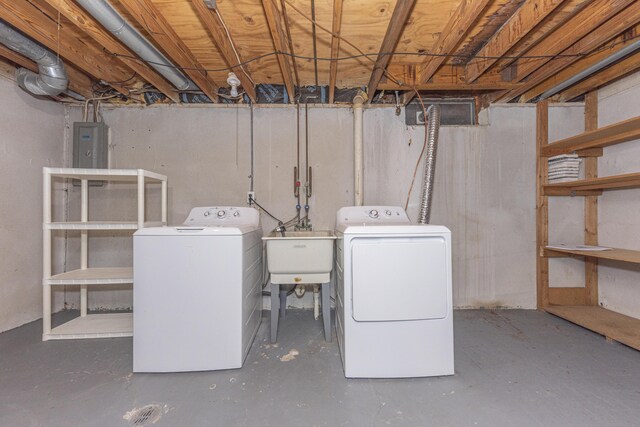 basement featuring sink, electric panel, and washing machine and dryer