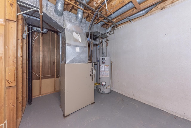 utility room featuring heating unit and gas water heater