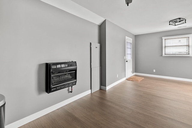 71039 Michigan Blvd, White Pigeon, MI 49099 - unfurnished living room featuring baseboards, heating unit, and wood finished floors