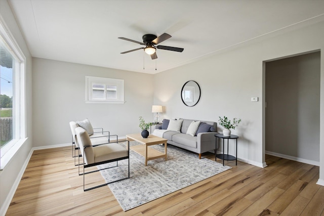 living room featuring ceiling fan and light hardwood / wood-style floors