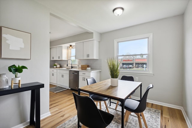 dining room with sink and light hardwood / wood-style flooring