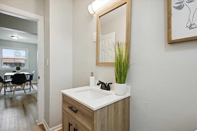 bathroom with hardwood / wood-style flooring and vanity