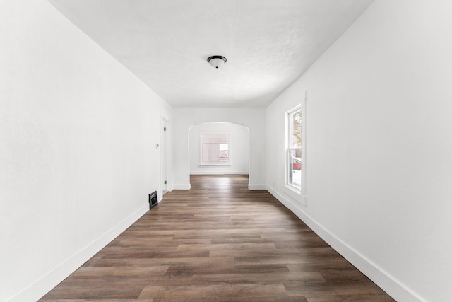 hall featuring dark hardwood / wood-style floors and a textured ceiling