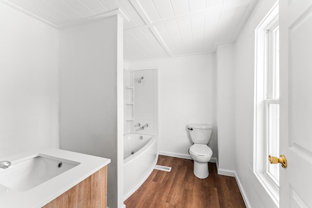 full bathroom with vanity, tub / shower combination, hardwood / wood-style floors, and toilet