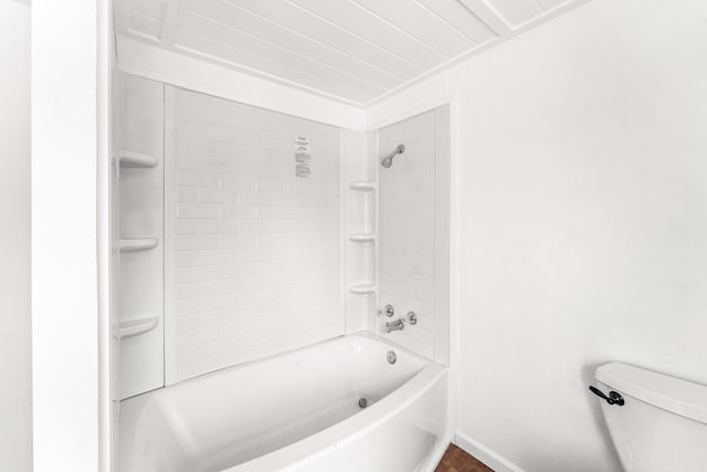 bathroom featuring tiled shower / bath and toilet