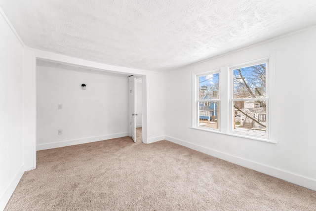 carpeted empty room with a textured ceiling