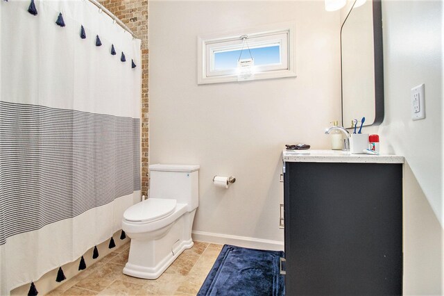 bathroom with a shower with curtain, vanity, tile patterned flooring, and toilet