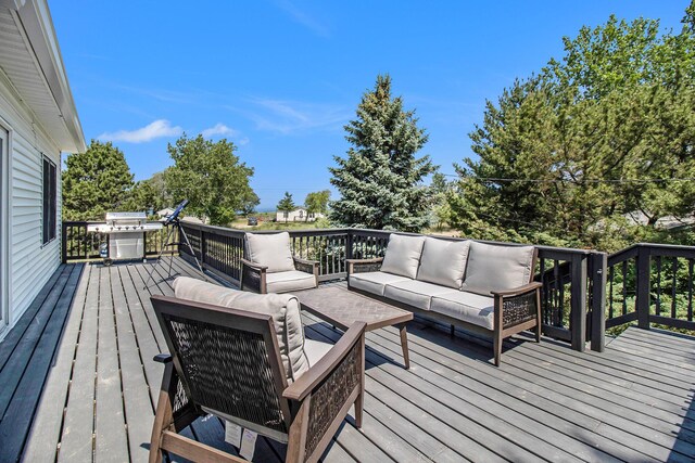 wooden terrace with area for grilling and an outdoor hangout area