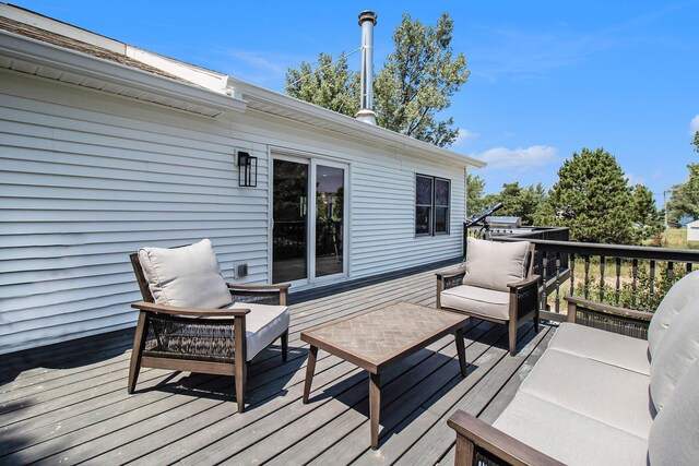 wooden terrace featuring an outdoor hangout area