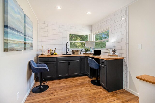 office space featuring sink and light hardwood / wood-style flooring