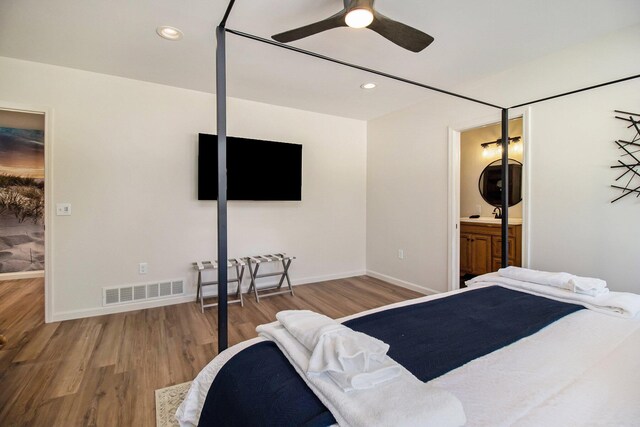 bedroom featuring ensuite bathroom, ceiling fan, and light wood-type flooring