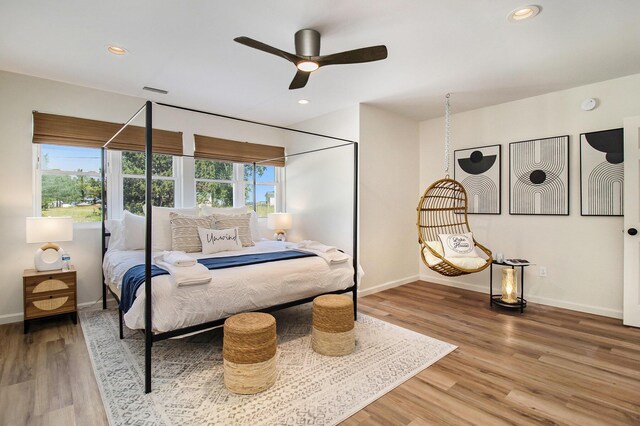 bedroom with wood-type flooring and ceiling fan