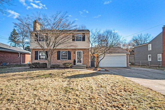 colonial-style house with driveway, brick siding, a chimney, and an attached garage