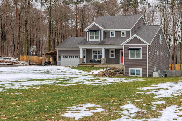 view of front of property with a yard, covered porch, and a garage