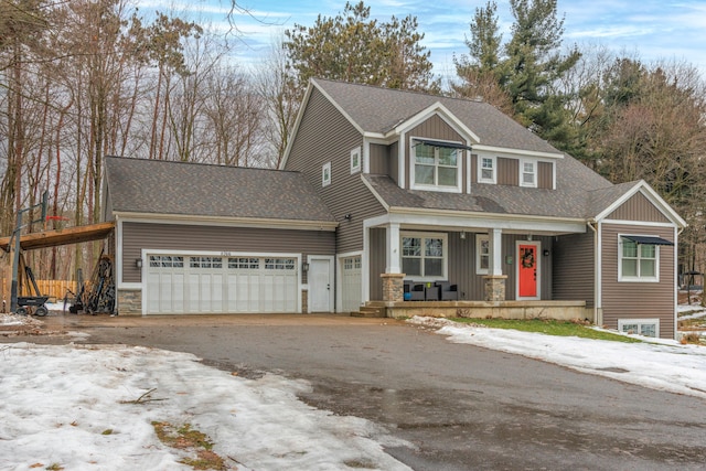 view of front facade featuring a porch and a garage