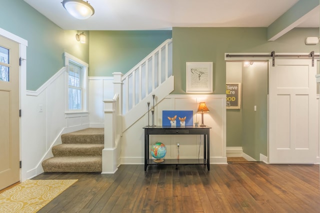 stairway featuring hardwood / wood-style flooring and a barn door