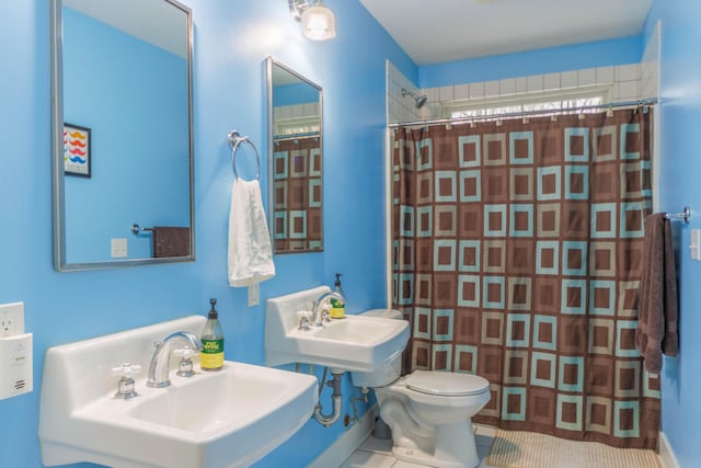 bathroom with sink, a shower with curtain, tile patterned flooring, and toilet