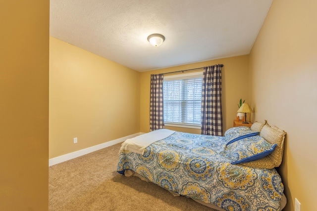 bedroom with carpet floors and a textured ceiling