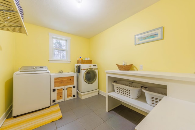 washroom featuring sink, tile patterned flooring, and washing machine and clothes dryer