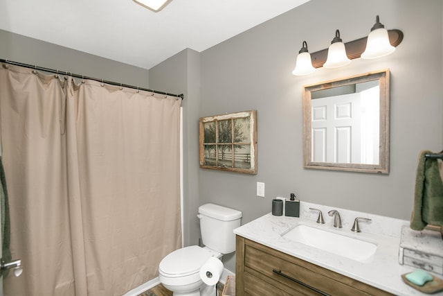 bathroom with vanity, walk in shower, and toilet