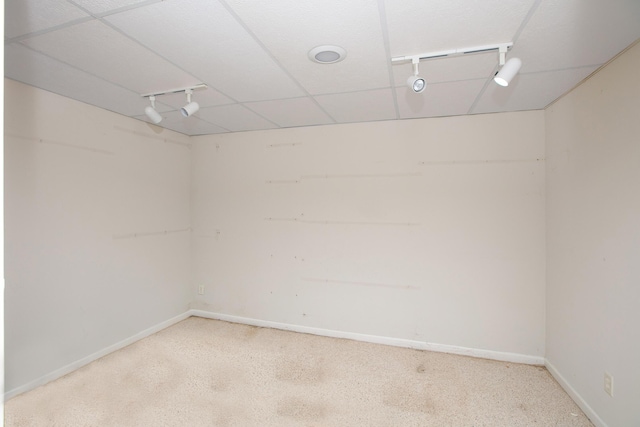 empty room featuring light carpet and track lighting