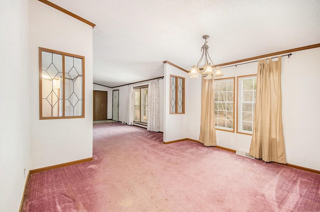 carpeted spare room featuring crown molding, a textured ceiling, and a notable chandelier