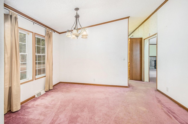 empty room featuring an inviting chandelier, ornamental molding, a textured ceiling, and carpet flooring