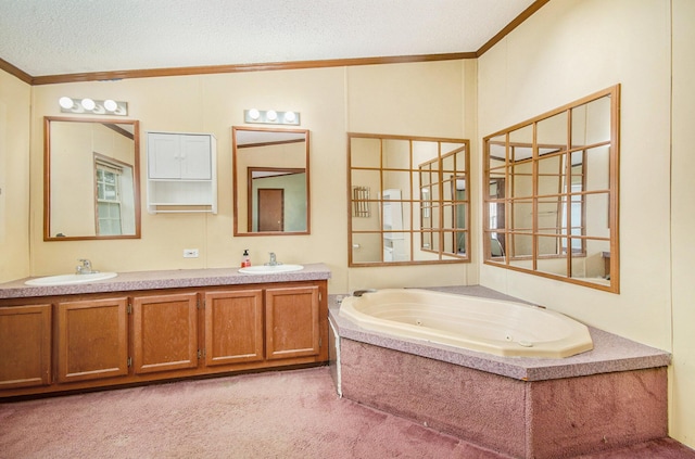 bathroom featuring vanity, crown molding, a bathing tub, and a textured ceiling