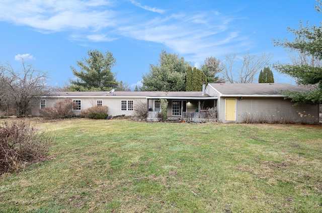 view of front facade with a front yard and covered porch