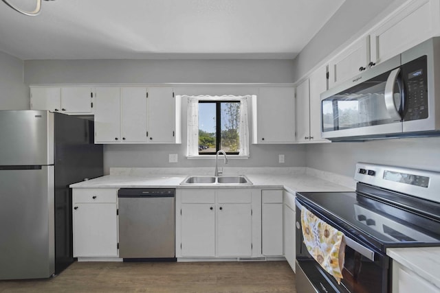 kitchen featuring white cabinetry, stainless steel appliances, dark hardwood / wood-style flooring, and sink