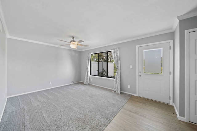 foyer entrance with ornamental molding, ceiling fan, and light hardwood / wood-style floors