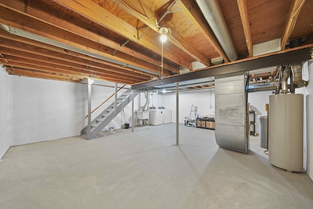 basement featuring sink, water heater, and washing machine and clothes dryer