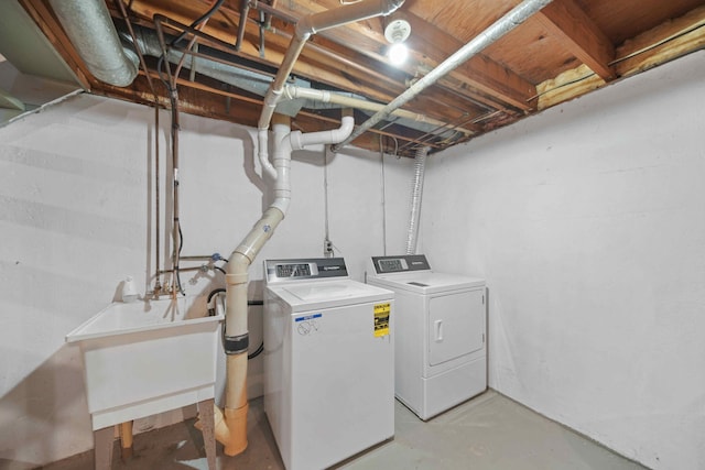 clothes washing area with sink and independent washer and dryer