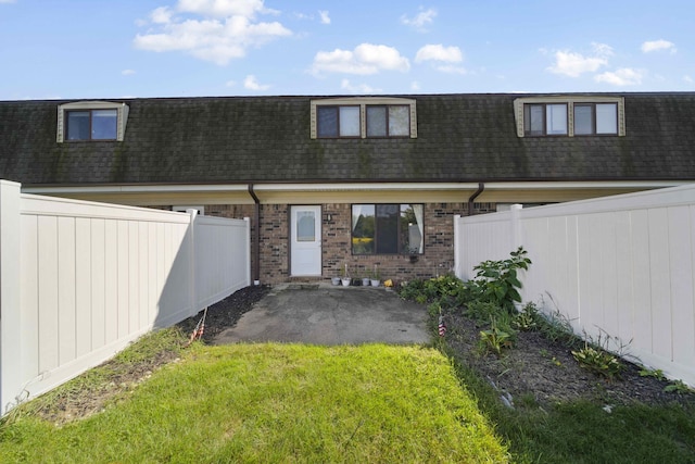 back of property with a patio and a lawn