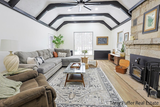 living room featuring hardwood / wood-style floors, vaulted ceiling, and ceiling fan