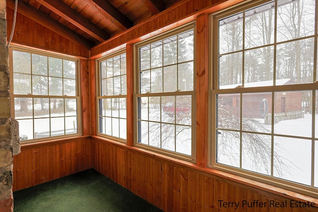 unfurnished sunroom with vaulted ceiling with beams and wood ceiling