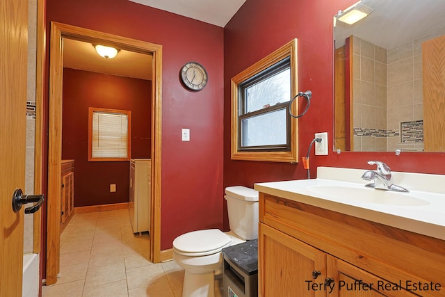 bathroom featuring vanity, tile patterned floors, and toilet