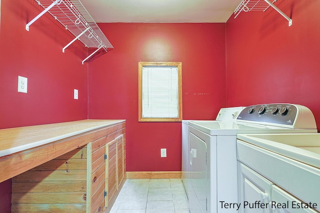 laundry area with cabinets, washer and clothes dryer, and light tile patterned floors