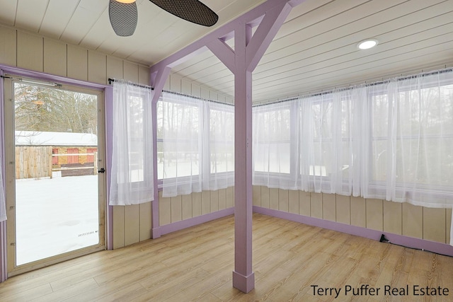 unfurnished sunroom with ceiling fan