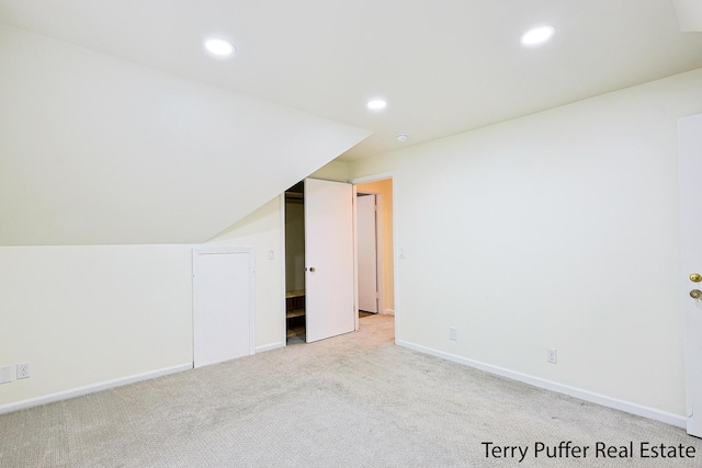 additional living space featuring light colored carpet