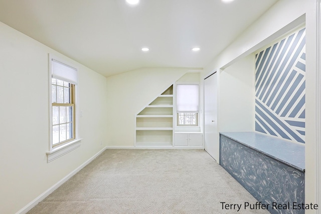 interior space with lofted ceiling and built in shelves