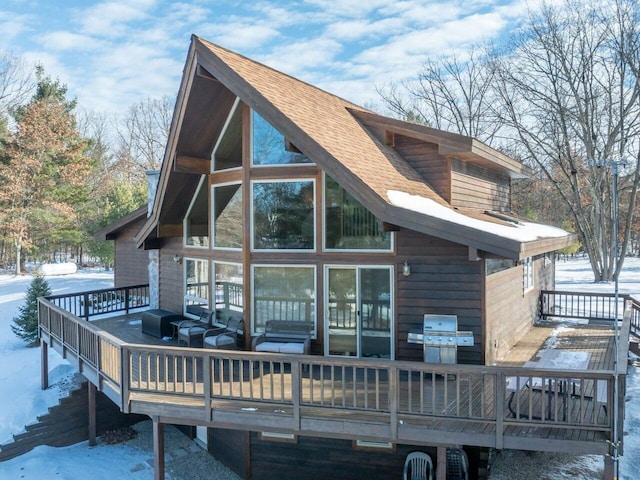 snow covered property featuring a deck