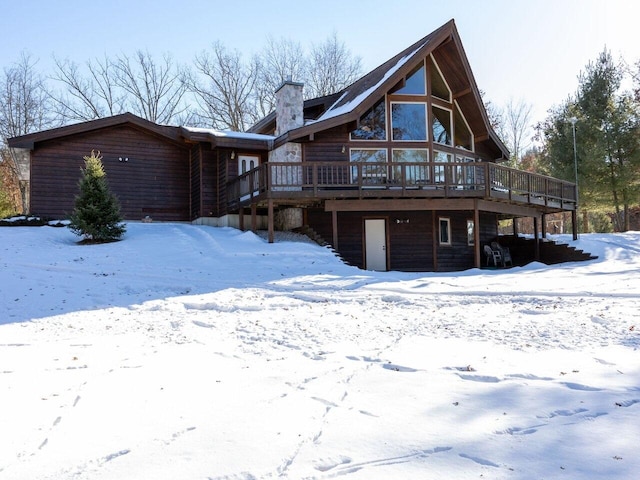 snow covered property featuring a wooden deck