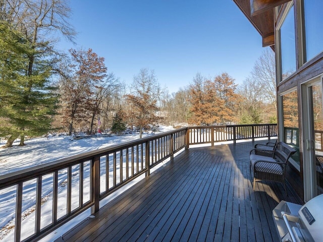 snow covered deck with grilling area