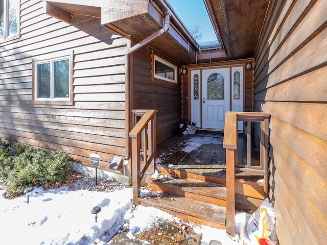 view of snow covered property entrance