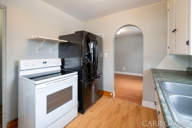 kitchen featuring sink, white range with electric cooktop, white cabinetry, black fridge with ice dispenser, and light wood-type flooring