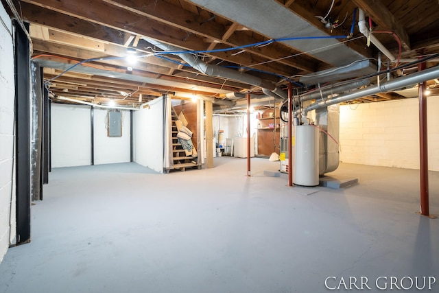 basement featuring electric panel and water heater